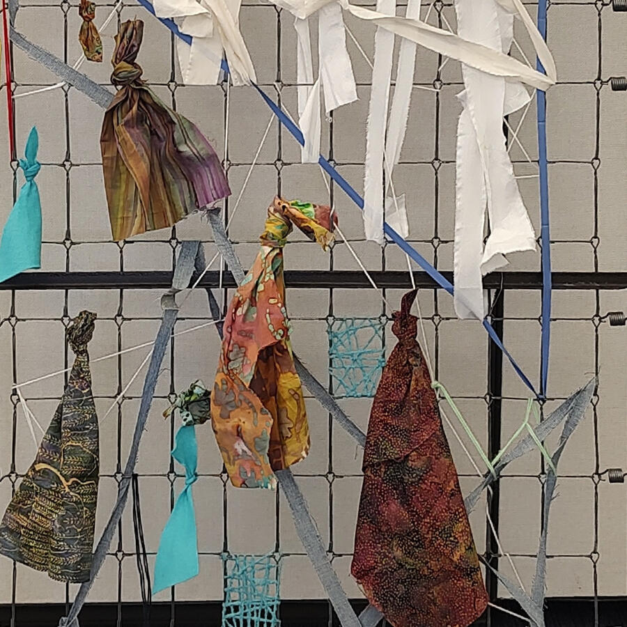 Recycled stripped box spring with textile art.