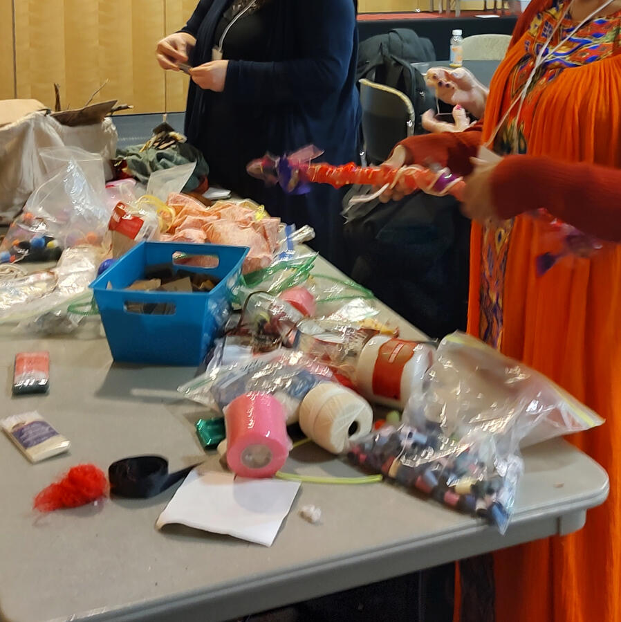 People making colorful sensory tools out of sticks and scraps.